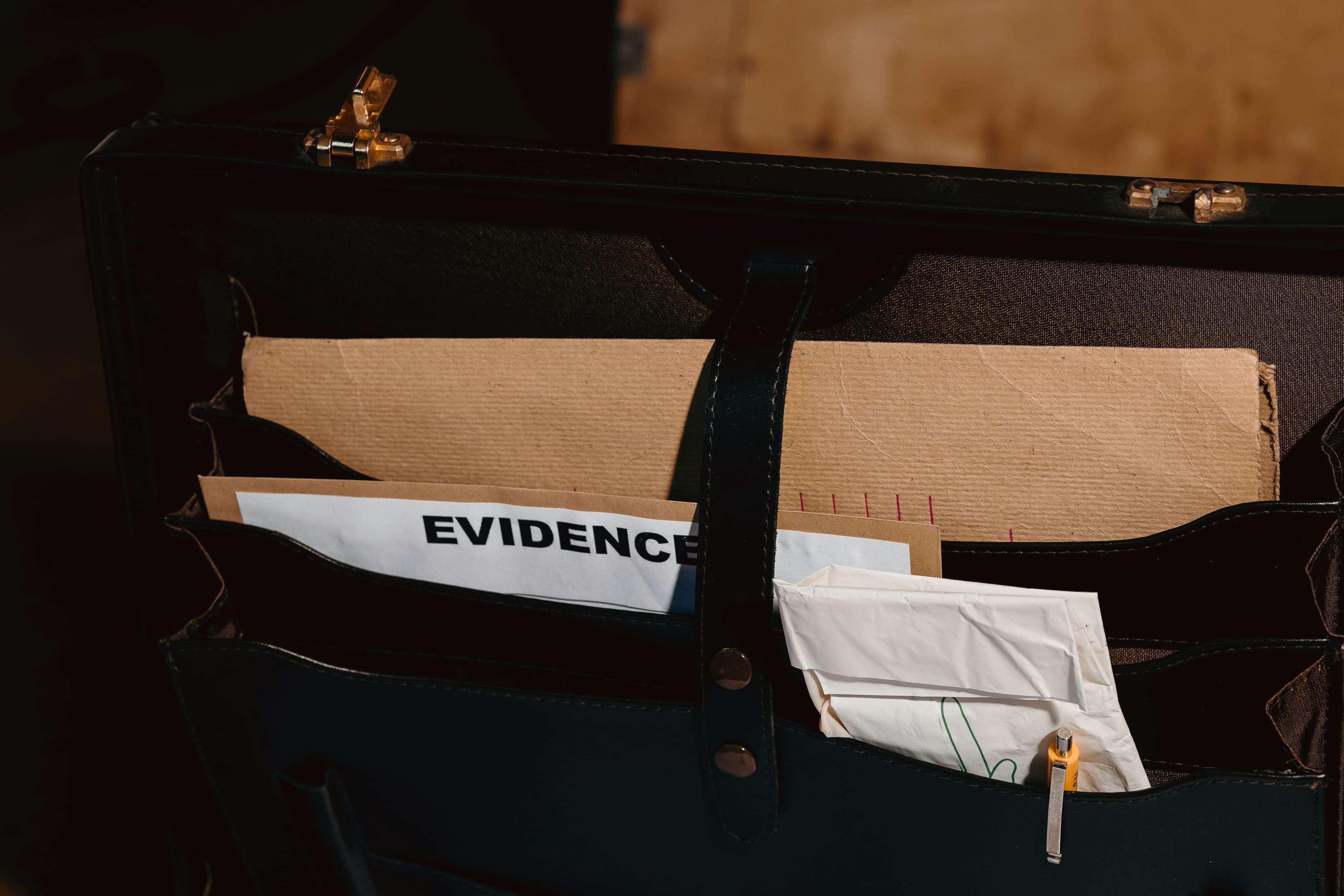 Briefcase and papers—archive prop photography.
